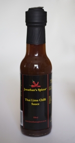 Tall round clear glass sealed bottle containing Jonathan's Spices thai lime chilli sauce